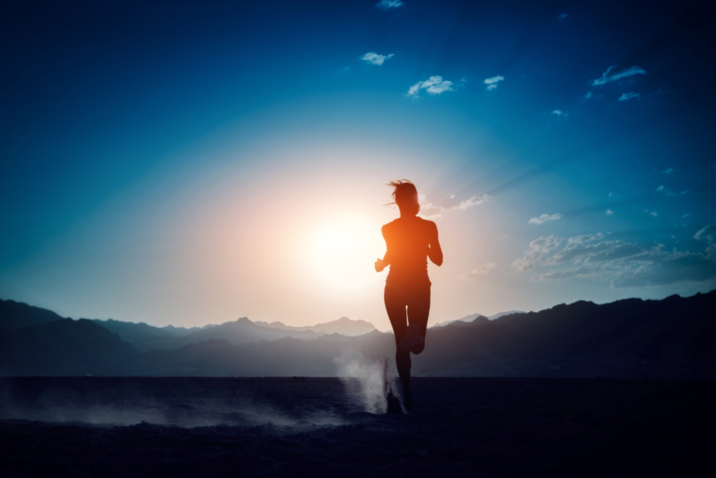 Lady running in the desert at sunset