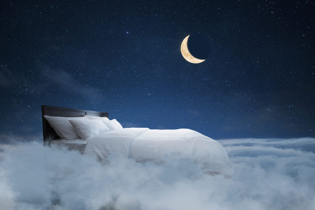 Bed with pillows and a blanket flies in the clouds with a night starry sky with the moon, creative idea. Sweet dream, concept. Night rest